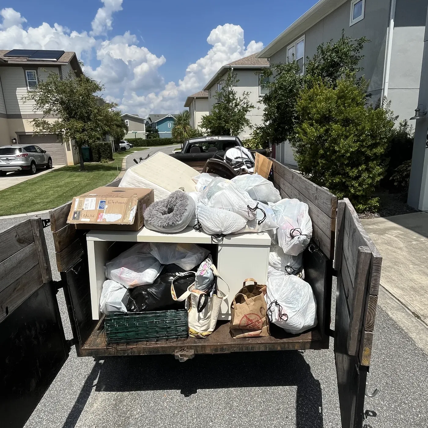 Bin Bandits trailer fully loaded with junk from a residential haul