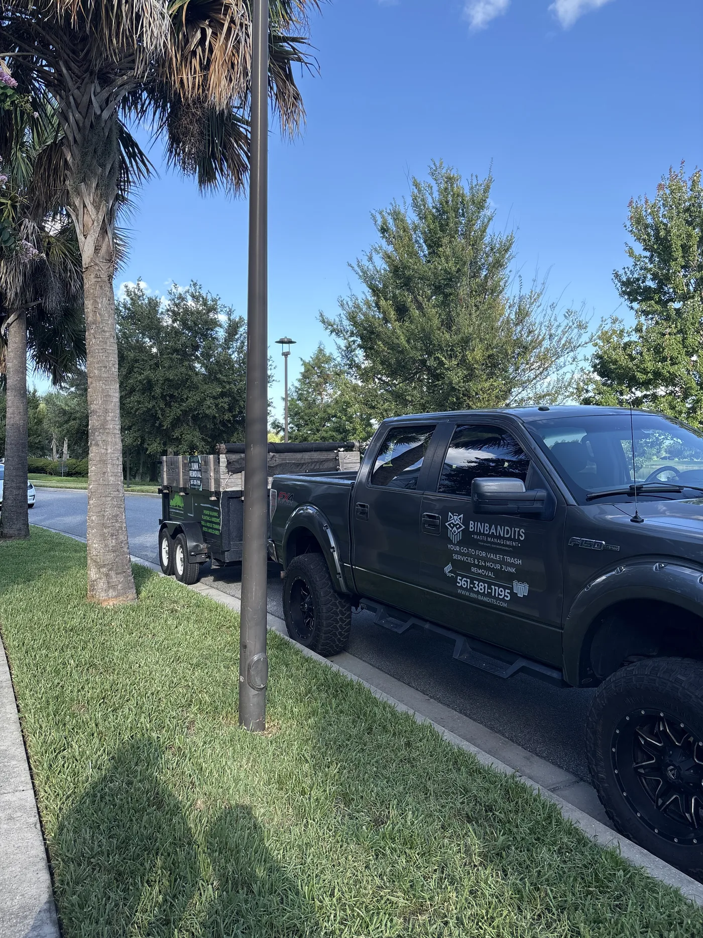 Bin Bandits truck loading pre-move junk from a residential home