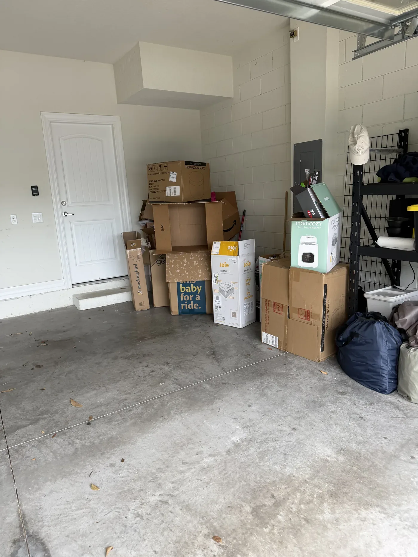 Garage corner stacked floor-to-ceiling with unlabeled dusty boxes