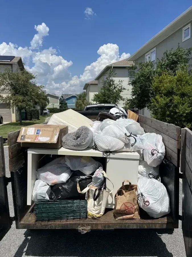 Dump trailer rental — clean dump trailer dropped off in a driveway ready to load